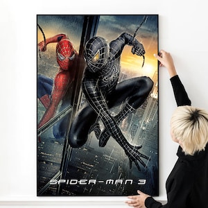 May include: A movie poster for Spider-Man 3 featuring two versions of Spider-Man, one in a red and blue suit and the other in a black suit. The poster has a dark background with a cityscape in the background.