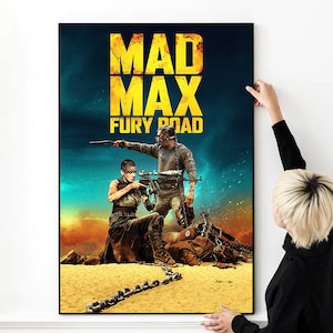 May include: A movie poster for Mad Max: Fury Road, featuring a black and white image of two characters, one holding a gun and the other holding a chain. The poster has a yellow background with the title "Mad Max: Fury Road" in large, yellow letters.