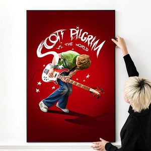 May include: A red poster with white text that reads "Scott Pilgrim vs. the World". The poster features a cartoon image of a man playing a bass guitar.