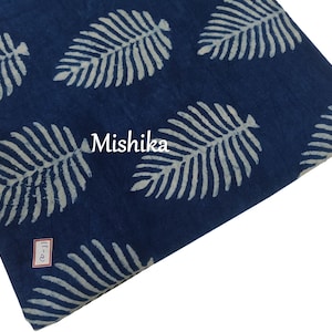 May include: Indigo blue fabric with a white leaf pattern. The fabric has the word "Mishika" printed on it.
