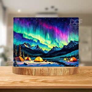 May include: A digital painting of a mountain landscape with a vibrant aurora borealis in the sky.  There are several yellow tents set up in the snow, suggesting a camping trip under the northern lights.