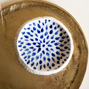 Ceramic bowl made of white clay with carving and painted with dark blue paint. image 1