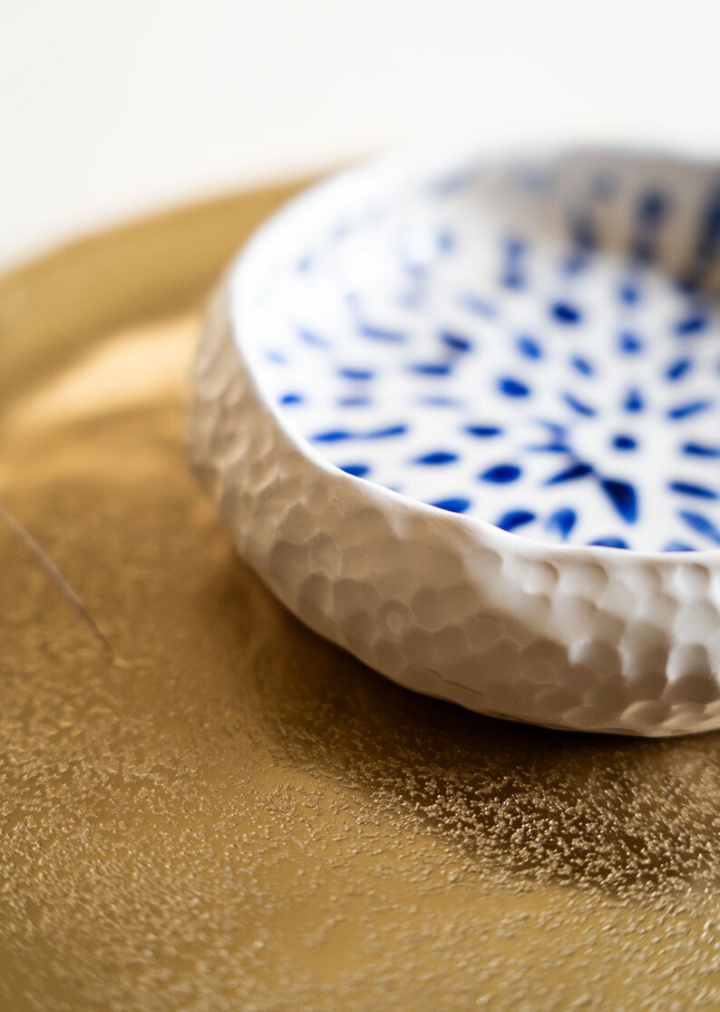 Ceramic bowl made of white clay with carving and painted with dark blue paint. image 10