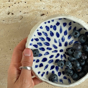 Ceramic bowl made of white clay with carving and painted with dark blue paint. image 2