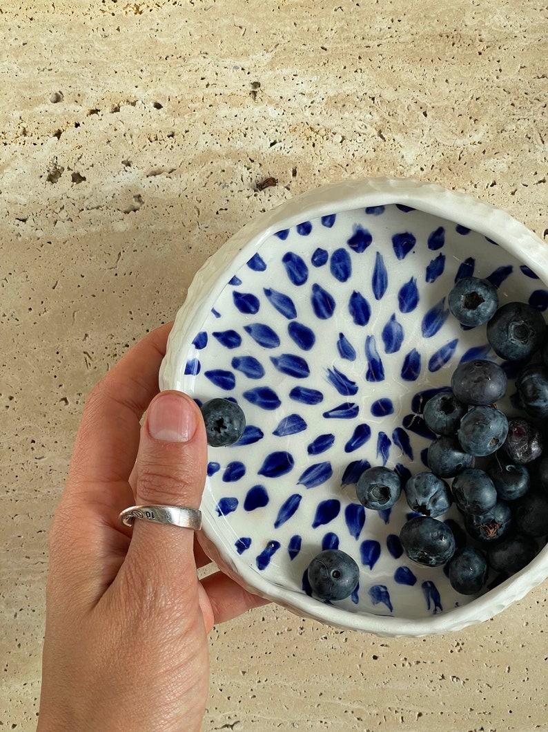 Ceramic bowl made of white clay with carving and painted with dark blue paint. image 2