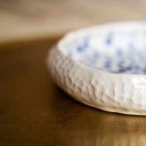 Ceramic bowl made of white clay with carving and painted with dark blue paint. image 8