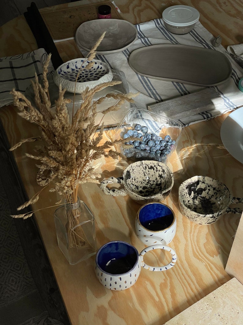 Ceramic bowl made of white clay with carving and painted with dark blue paint. image 3