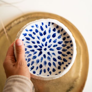 Ceramic bowl made of white clay with carving and painted with dark blue paint. image 9