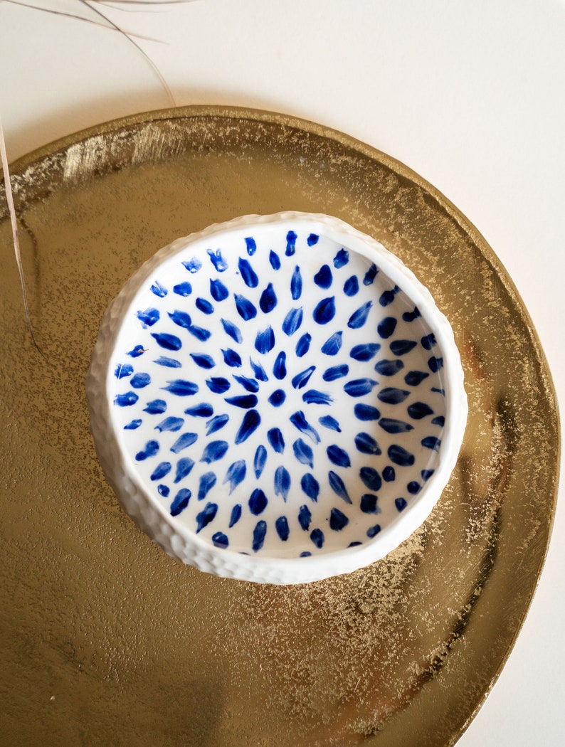 Ceramic bowl made of white clay with carving and painted with dark blue paint. image 1