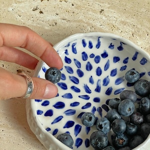 Ceramic bowl made of white clay with carving and painted with dark blue paint. image 5