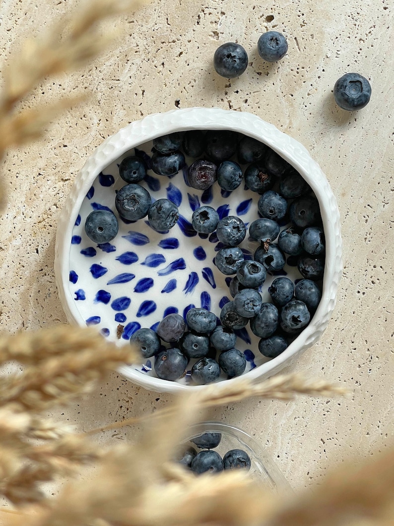 Ceramic bowl made of white clay with carving and painted with dark blue paint. image 4