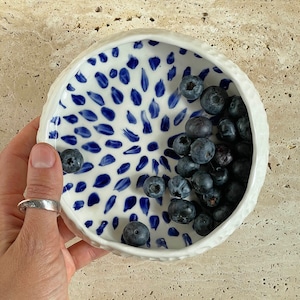 Ceramic bowl made of white clay with carving and painted with dark blue paint. image 7