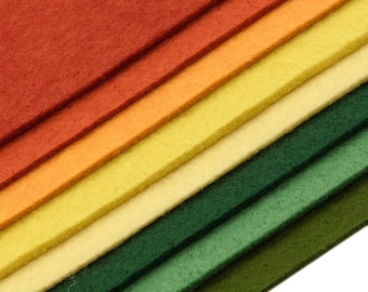 May include: A stack of felt fabric sheets in various shades of orange, yellow, and green. The sheets are arranged in a diagonal pattern, creating a gradient effect.