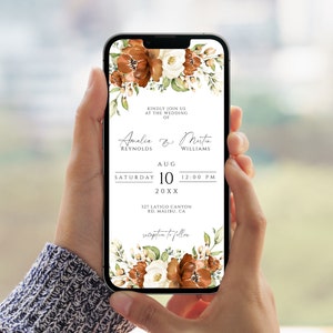 Puede incluir: Una invitación de boda con un diseño floral en tonos marrones, blancos y verdes. La invitación dice "Kindly join us at the wedding of Amalia & Martin Reynolds Williams Aug 10 20XX 12:00 PM 127 Latigo Canyon Rd. Malibu, CA reception to follow"