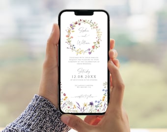 May include: A smartphone displays a wedding invitation with floral accents. The invitation features the names "Sophie and William" within a floral wreath. Text includes the date, time, and location of the wedding.