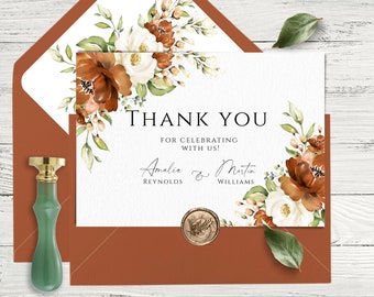 May include: A thank you card featuring a watercolour floral design in shades of brown, white, and green. The text reads "Thank You for celebrating with us! Amalia Reynolds & Martin Williams".