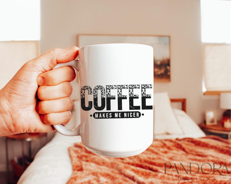 May include: White ceramic coffee mug with black text that reads "Coffee Makes Me Nicer."