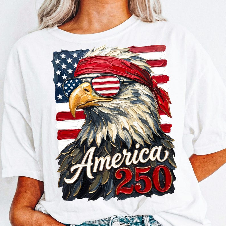 The design shows a detailed patriotic eagle wearing an American flag bandana and sunglasses in front of a USA flag background with the text “America 250” below it.