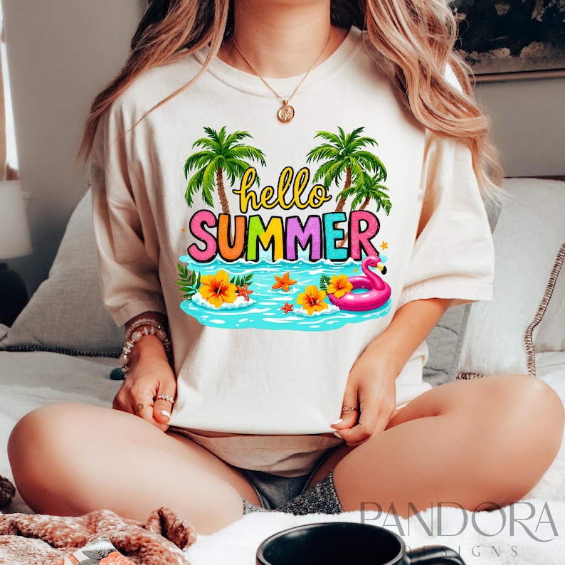 May include: A white t-shirt with a colorful graphic design featuring palm trees, a flamingo float, and the text "hello summer".