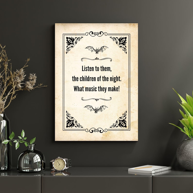 May include: A framed print with a vintage design. The text reads "Listen to them, the children of the night. What music they make!" in a serif font. The design includes bat illustrations and decorative corner elements.