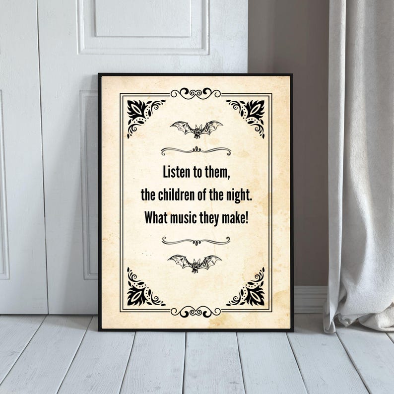 May include: A framed print with a vintage design. The artwork displays the quote: "Listen to them, the children of the night. What music they make!" Black decorative flourishes and bat illustrations are set against a cream-colored background.