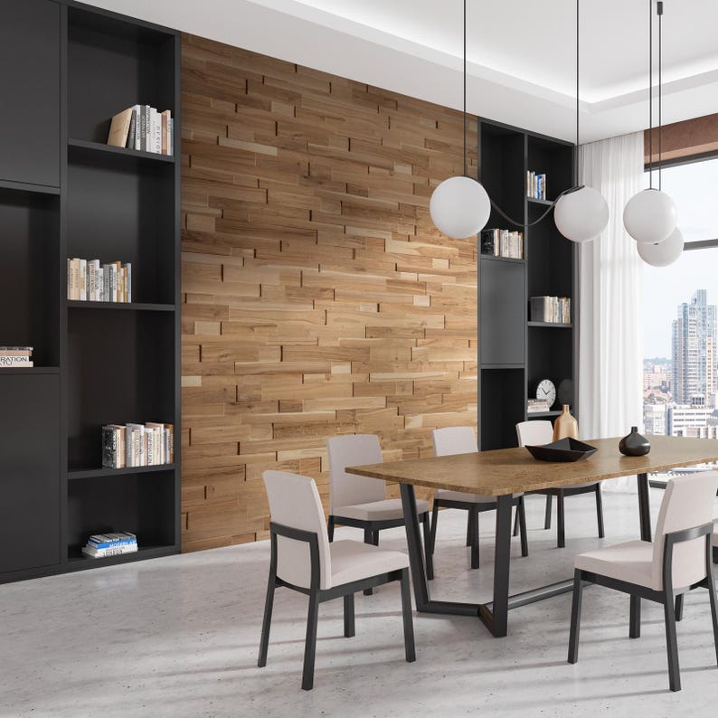 May include: A modern dining room with a wooden wall, a black bookshelf, and a rectangular dining table with six chairs. The table has a light wood top and a black metal base. There are three white globe pendant lights hanging above the table.