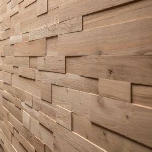 May include: A wall covered in light brown wood panels, arranged in a staggered pattern. The panels are made of natural wood with a rustic finish.