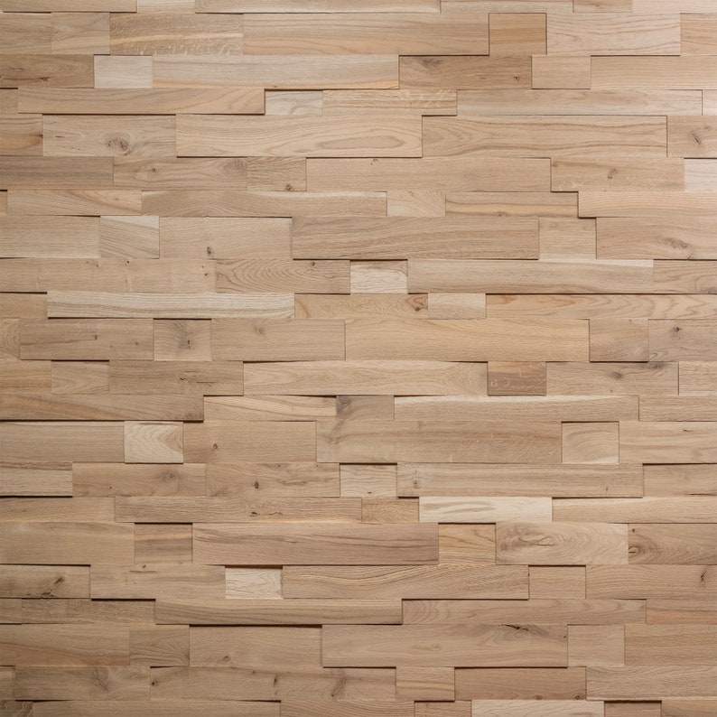 May include: A wall covered in a wood paneling made of various sized rectangular pieces of wood. The wood is a light brown color.