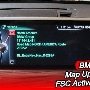 May include: A car's dashboard display shows the "Version" screen with details including "North America" and "BMW Group." The screen also displays "Road Map NORTH AMERICA Route 2022-2." The bottom right corner has the text "BMW Map Update + FSC Activation Code."