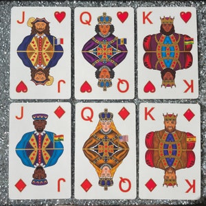 May include: A set of nine playing cards featuring a Jack, Queen, and King of hearts and diamonds. The cards are illustrated with people wearing crowns and traditional clothing. The suits are displayed in the top right corner of each card.
