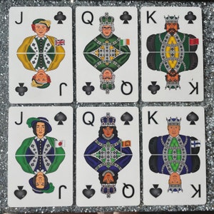 May include: A set of ten playing cards featuring the Jack, Queen, and King of spades. Each card has a different person wearing a crown and a suit of armor. The cards are in a traditional playing card style with a black spade symbol in the top right corner.