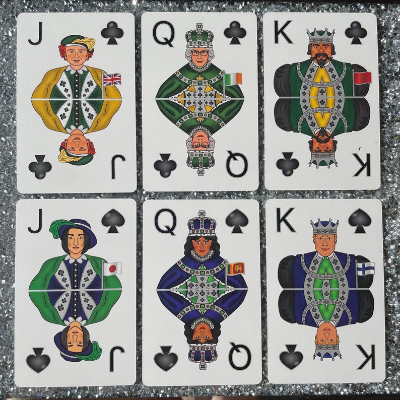 May include: A set of ten playing cards featuring the Jack, Queen, and King of spades. Each card has a different person wearing a crown and a suit of armor. The cards are in a traditional playing card style with a black spade symbol in the top right corner.