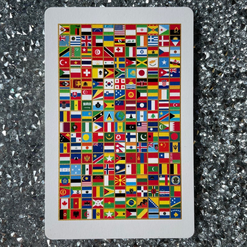 May include: A white card with a grid of colorful flags from around the world. The flags are arranged in a grid pattern and are all different sizes. The card is surrounded by a white border.