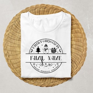May include: White t-shirt with a round Family Christmas design. The design includes a Christmas tree, snowman, and gift box. The text reads "FAMILY CHRISTMAS" above and "FAMILY NAME" below, with "MAKING MEMORIES TOGETHER" at the bottom.