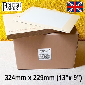 May include: A brown cardboard box with a label that reads "British Paper" and contains 125 kraft paper envelopes. The envelopes are 13 inches by 9 inches and are stacked on top of each other. The box is sitting on a yellow surface.