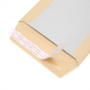 May include: A brown paper envelope with a white adhesive strip. The strip has the text "REMOVE TO EXPOSE ADHESIVE" printed on it.