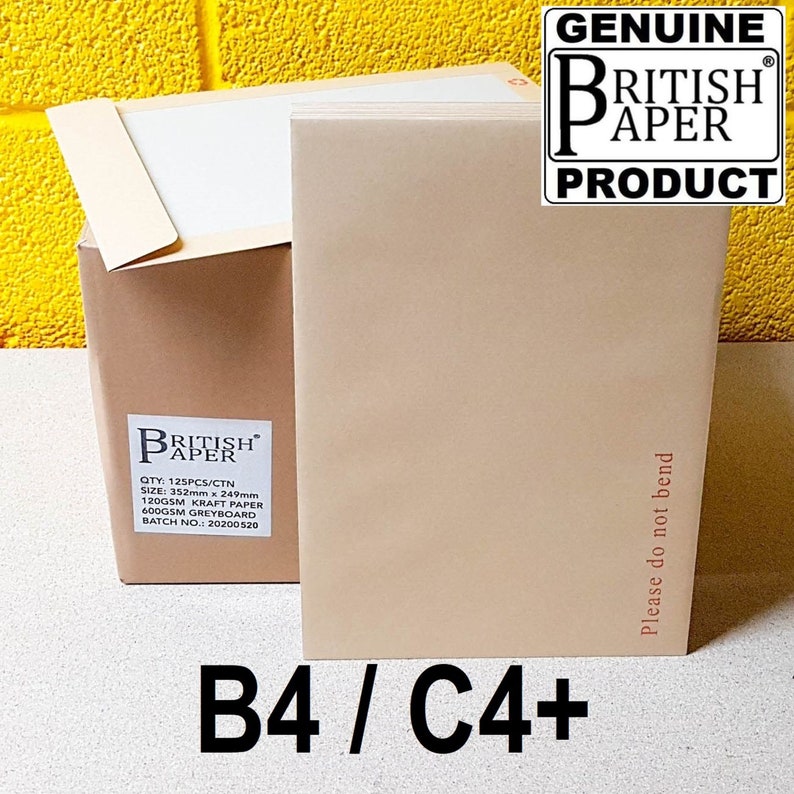 May include: A brown cardboard box with the text "British Paper" and product details. The box is labeled "B4/C4+" and has a "Genuine British Paper Product" label. The box is sitting on a yellow surface.