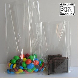 May include: Two clear plastic bags, one larger than the other, filled with colourful candy and chocolate bars. The bags are made by Genuine British Paper Products.
