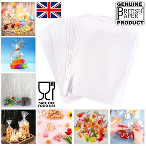 May include: A pack of 50 clear cellophane bags, perfect for packaging small gifts or treats. The bags are made of food-safe plastic and are ideal for use in a variety of settings, such as parties, weddings, or special events. The bags are shown with various items inside, such as sweets, biscuits, and other small gifts. The bags are also shown being tied with ribbon and bows. The bags are made in the UK and are a genuine British product.