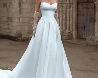 CUSTOM ORDER a wedding dress with an A-line skirt, leg slit, and a train, featuring a triangular corset and an embroidered pearl