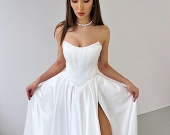 Elegant Satin Wedding Dress with Basque Corset, A-Line Silhouette, Strapless Bridal Gown with Pockets, Slit, and Small Train.