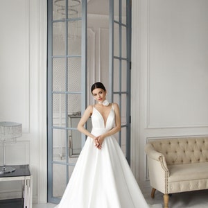 Elegant white Satin A-Line Bridal Gown with Plunging deep Neckline and Minimalist Bow Detail Timeless Wedding Dress Elegance with Straps image 3