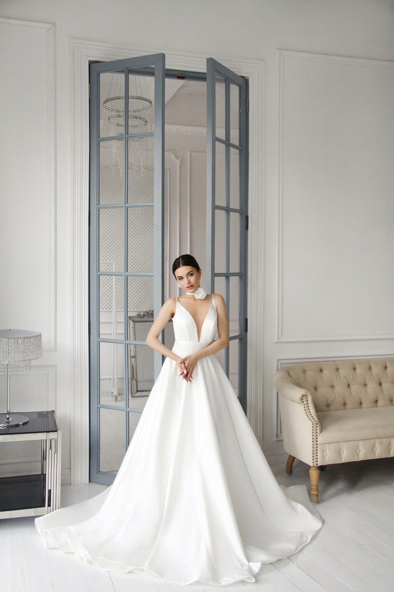 Elegant white Satin A-Line Bridal Gown with Plunging deep Neckline and Minimalist Bow Detail Timeless Wedding Dress Elegance with Straps image 3