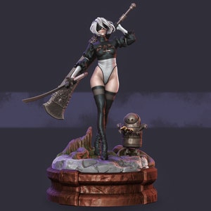 May include: A detailed figurine of a character from the game Nier: Automata. The figure is wearing a black and white outfit, holding a large sword and a staff. A small robot companion stands nearby on a rocky base.