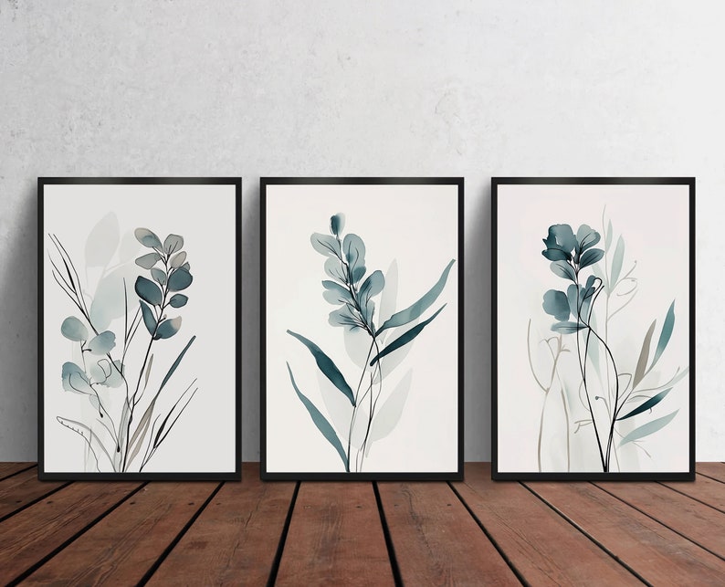 May include: Set of three framed watercolor prints featuring abstract floral designs in shades of blue and green on a white background.