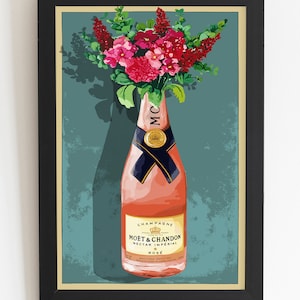 May include: A framed vintage poster featuring a bottle of Mo&euml;t & Chandon Nectar Imperial Ros&eacute; champagne with a bouquet of pink flowers in the background. The poster has a teal background with a white border.