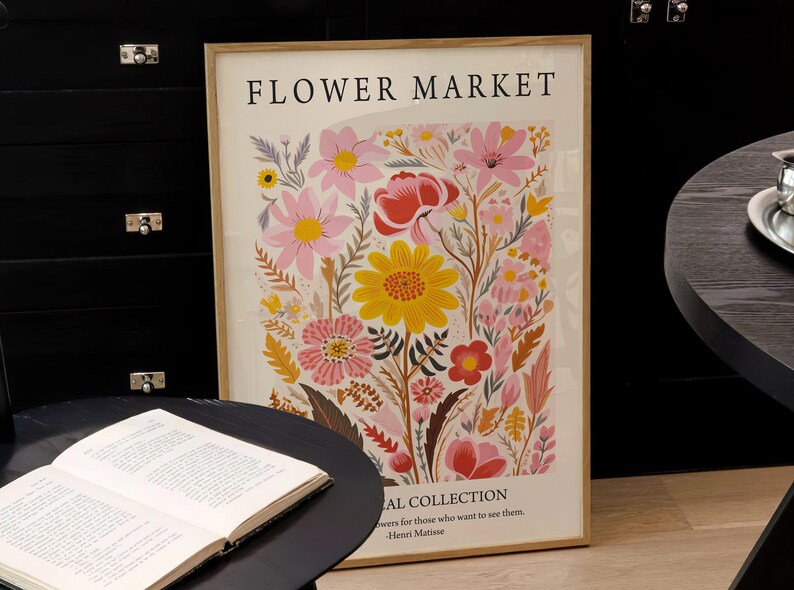 May include: A framed print with a floral design featuring pink, yellow, red, and orange flowers. The print has the text "FLOWER MARKET" and "AL COLLECTION" with a quote by Henri Matisse.