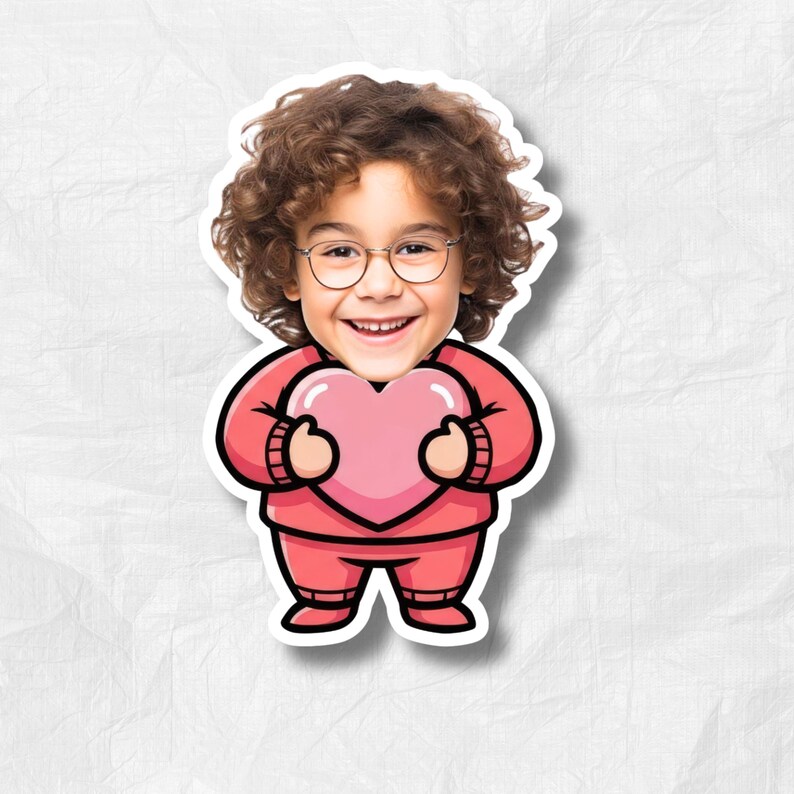 May include: A sticker featuring a cartoon illustration of a child with curly brown hair and glasses, holding a pink heart. The child is wearing a pink outfit. The sticker has a white border and is set against a textured white background.