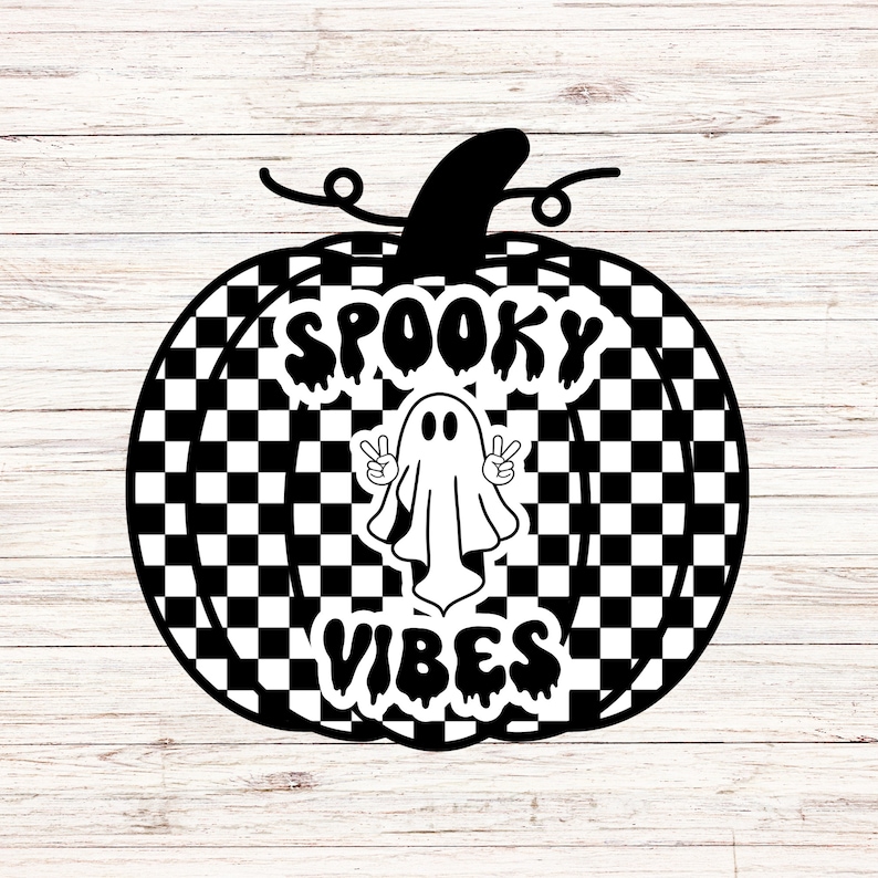 May include: A black and white pumpkin design with a checkered pattern. The pumpkin features the words "Spooky Vibes" and a ghost making a peace sign. The design is on a white wooden background.