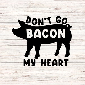May include: Black silhouette of a pig with the words "Don't Go Bacon My Heart" in bold, white letters. The design is set against a white, wood-grain background, creating a rustic and humorous aesthetic.